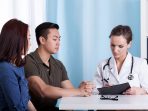 Asian couple during visit at doctor's office promil